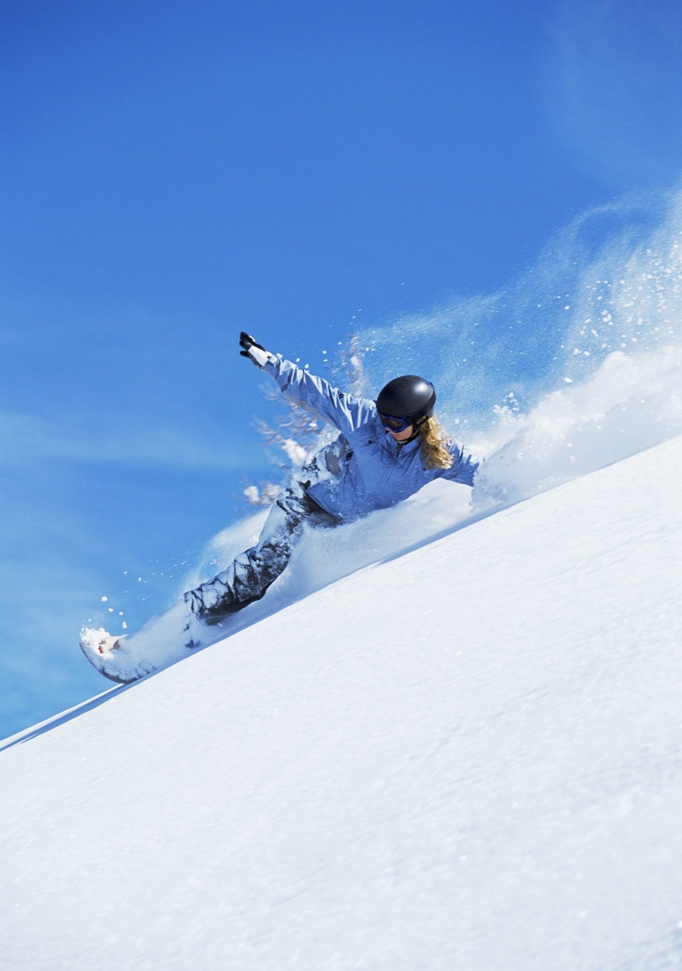 Young woman snowboarding e1635489715352.jpg